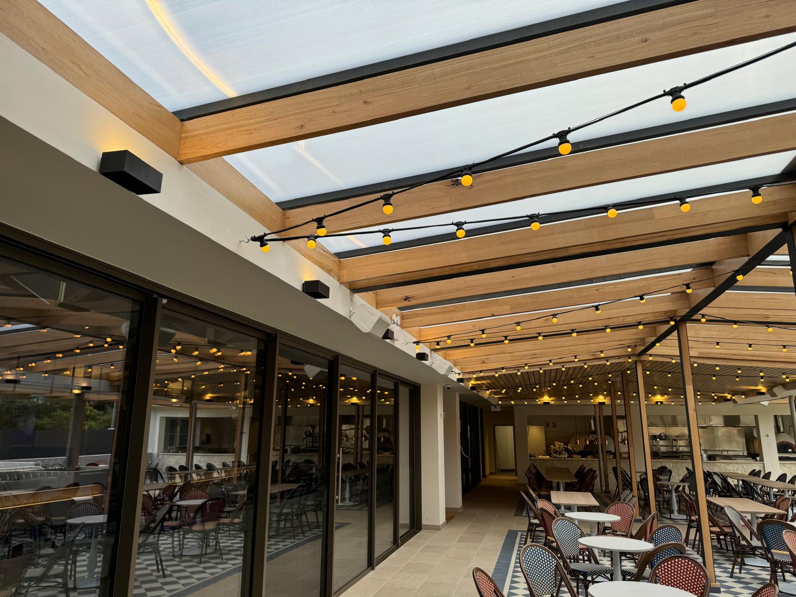 The finished courtyard speaker installation, integrated into the covered outdoor stage area.