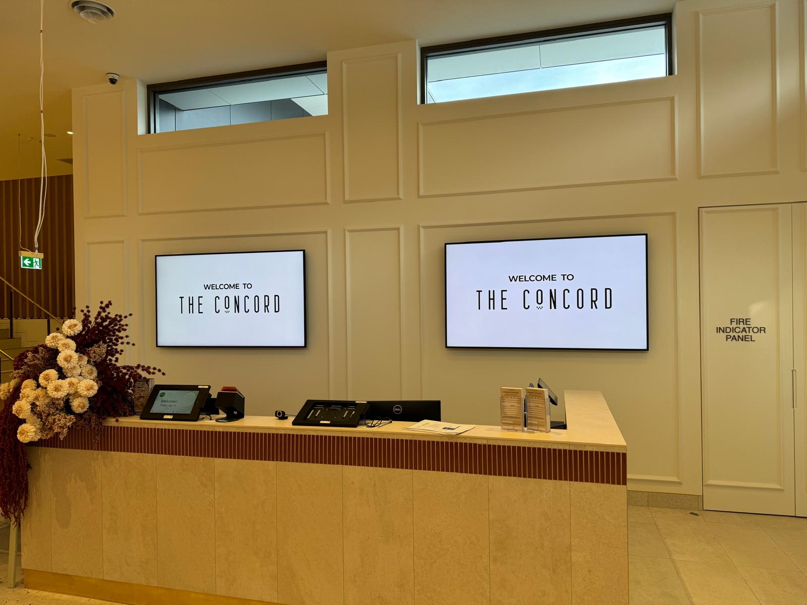 The finished entry displays showing The Concord Club's branding as guests arrive.