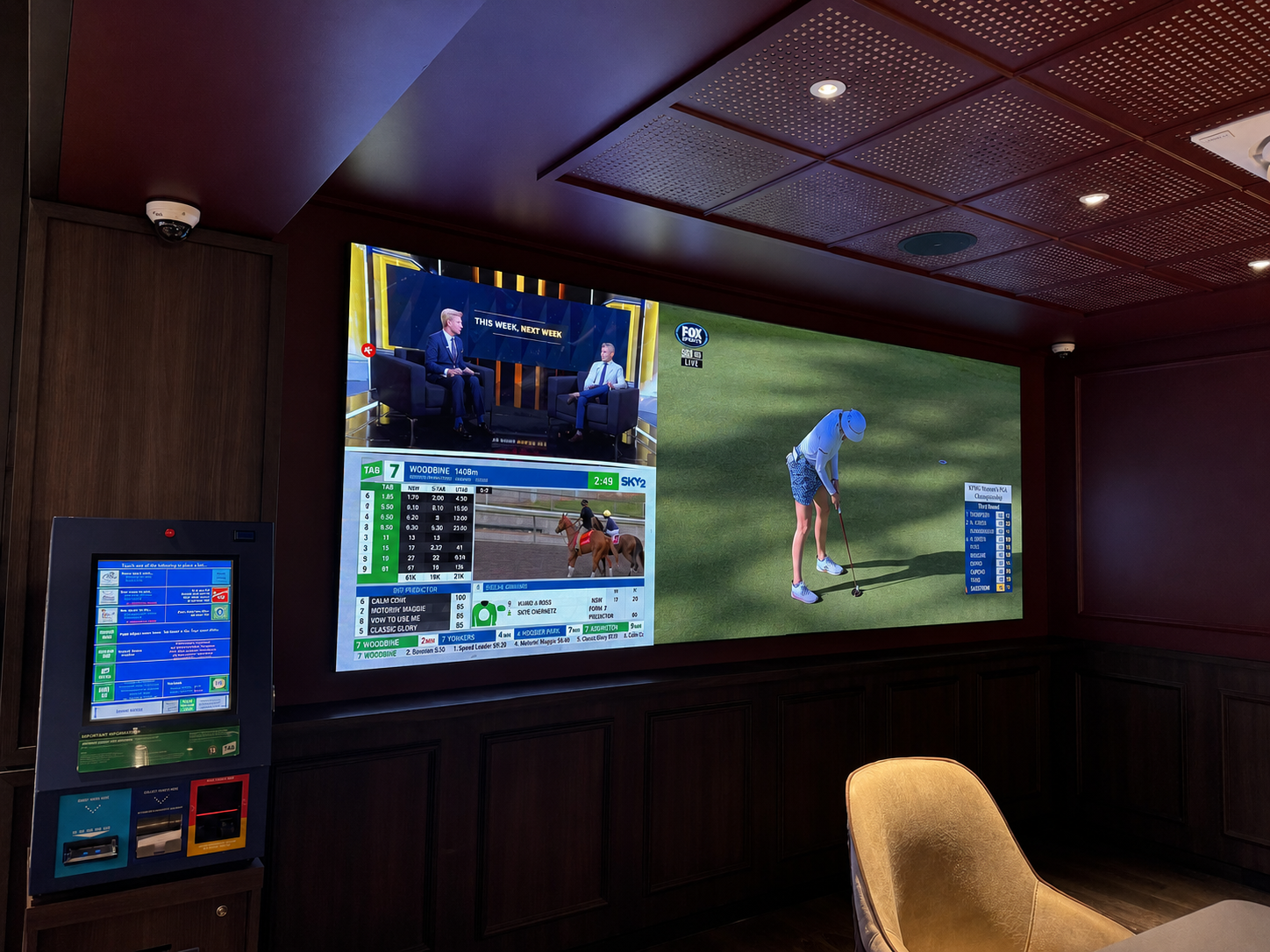 The finished TAB area display showing live racing and sports content alongside the betting terminal.