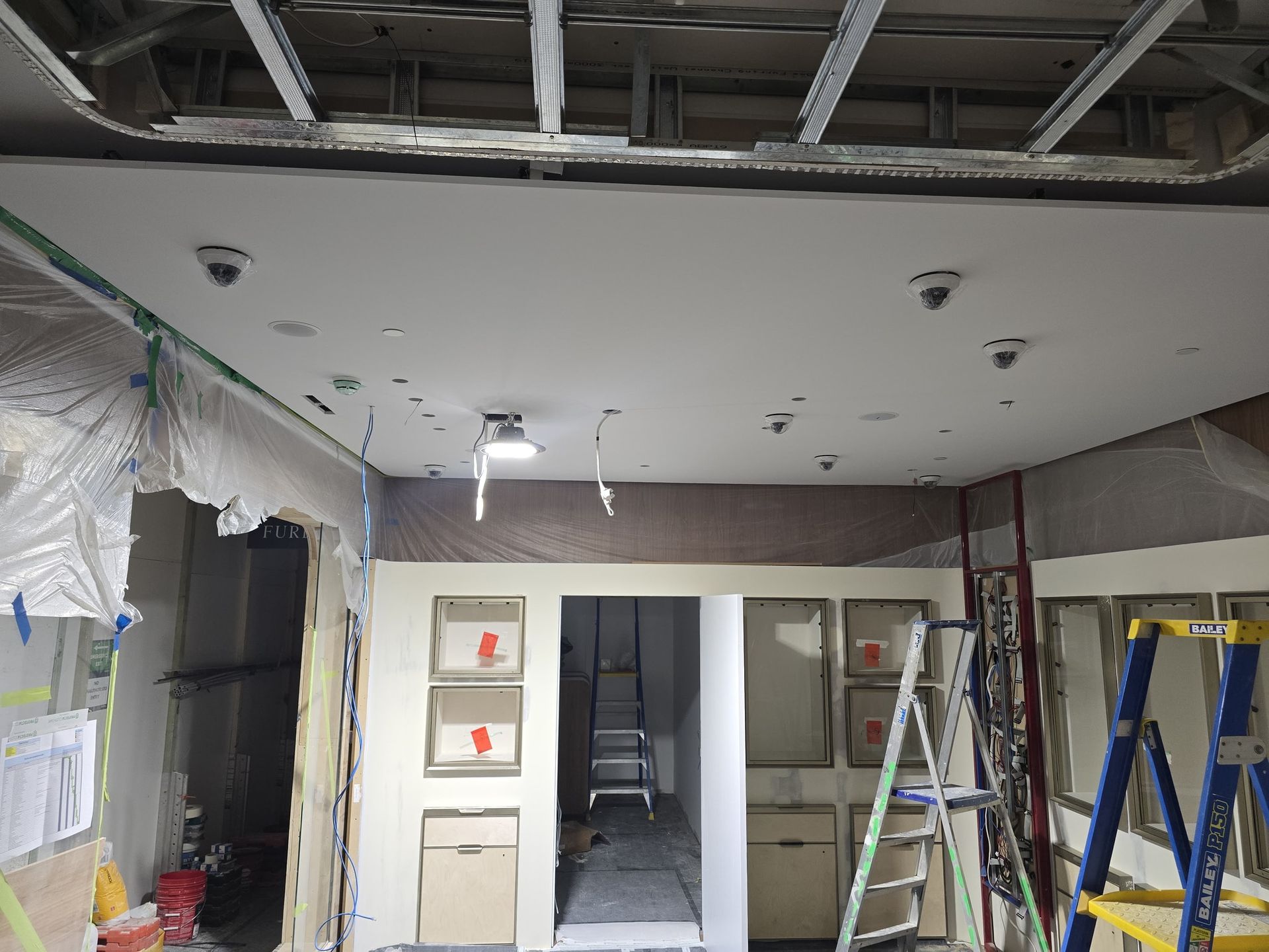 Installation-stage view showing the CCTV camera layout during the retail fitout, before ceiling and interior works were fully completed.